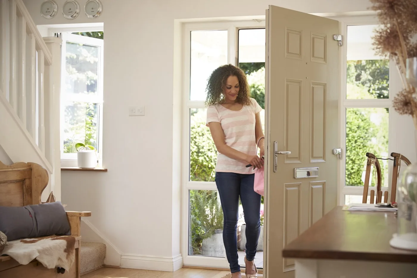 Homeowner opening the front door of her newly renovated home